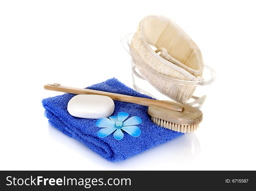 Spa essentials in blue on white background, reflective surface. Spa essentials in blue on white background, reflective surface