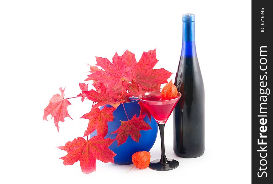 Red maple on white background with wine in wine glass