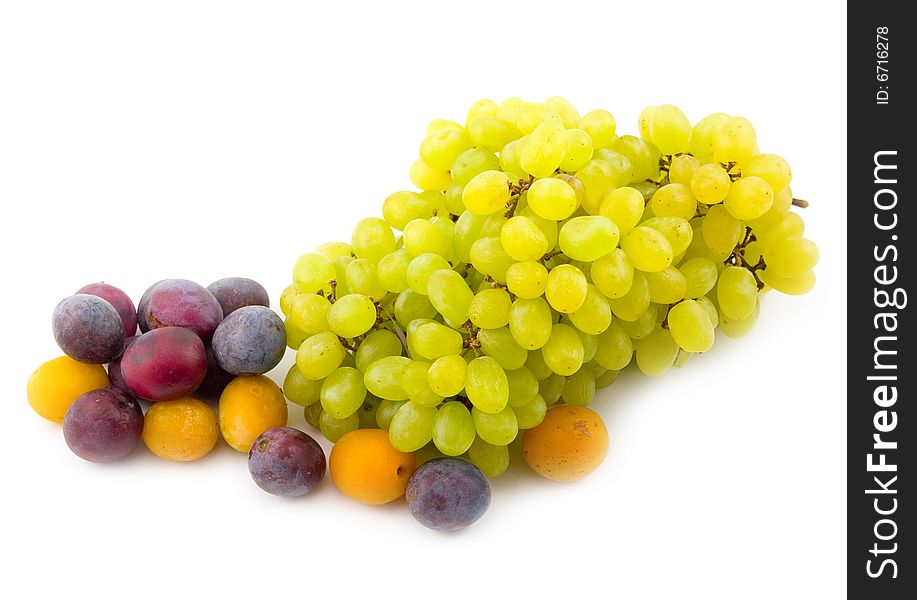 Tasty useful and beautiful fruit of berry grapes plums on white background. Tasty useful and beautiful fruit of berry grapes plums on white background