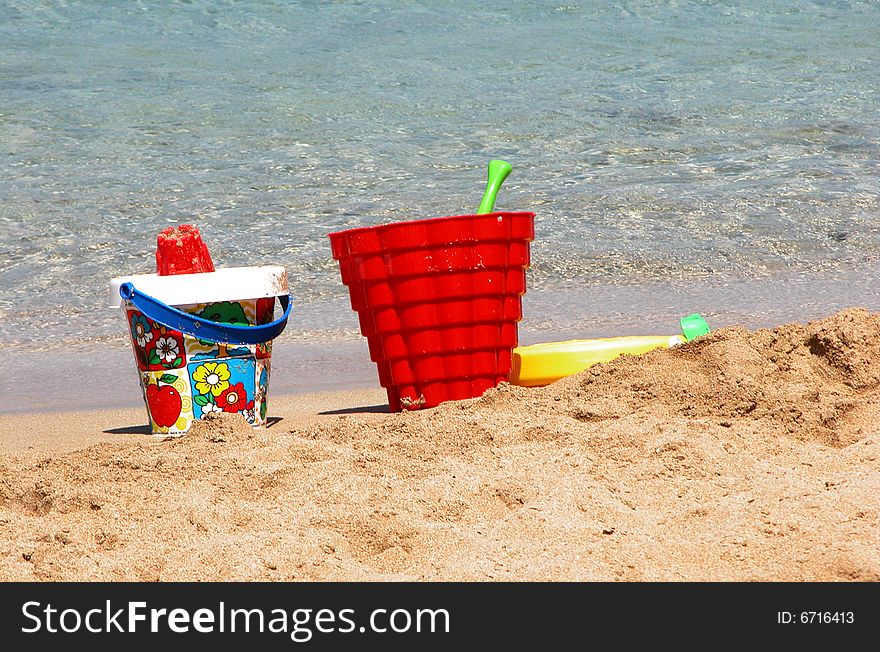 Colorful beach toys on sand