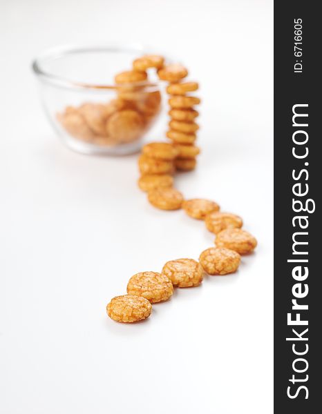 Translucent bowl of japanese crackers isolated on white as if running away from the bowl