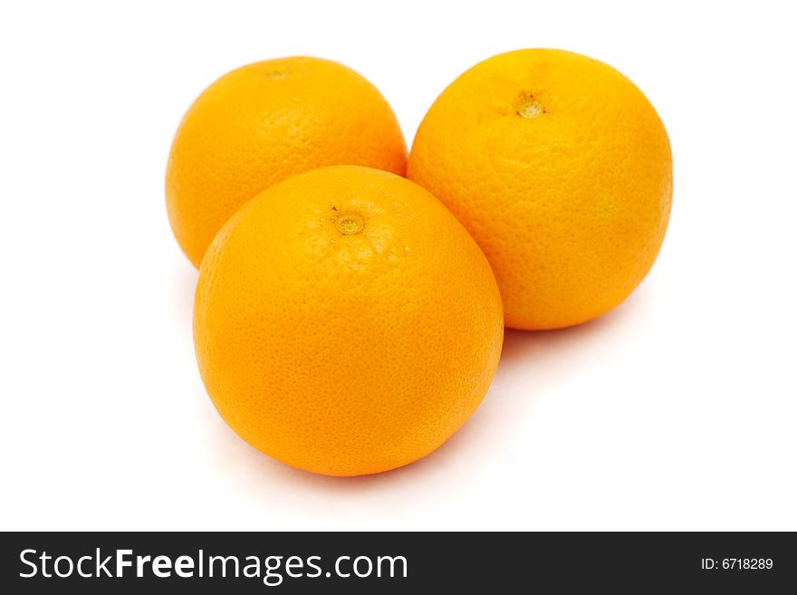 Close up of three oranges isolated on white background.