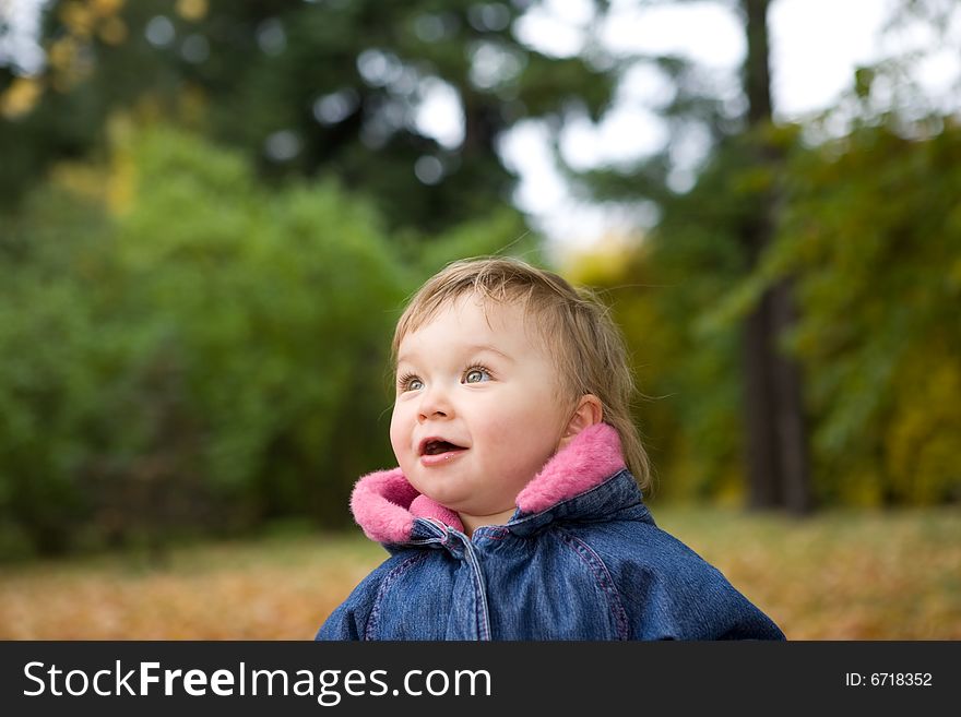 Happy baby girl playing in park with leaves. Happy baby girl playing in park with leaves