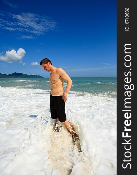 Masculine caucasian man standing on the beach. Masculine caucasian man standing on the beach