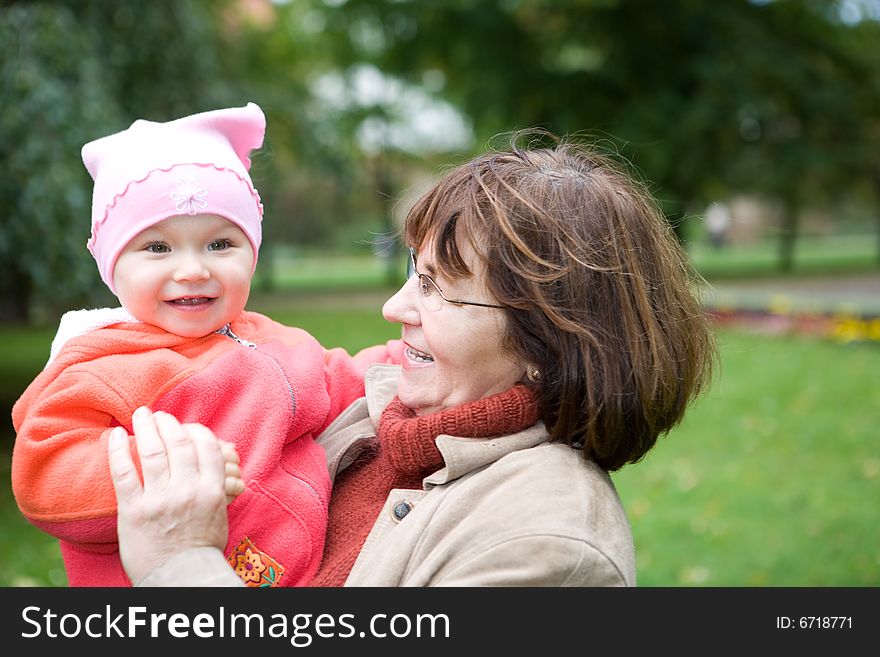 Grandmother with baby girl together in park. Grandmother with baby girl together in park