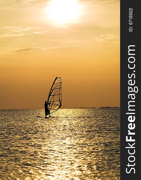 Silhouette of a windsurfer on a sunset