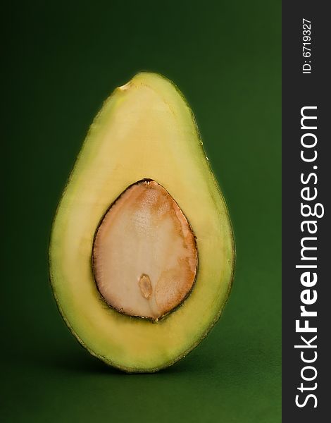 Avocado close-up isolated on green background