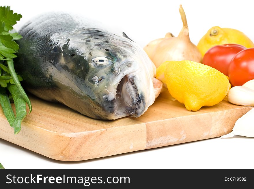 Fresh raw salmon with vegetables on a white background. Fresh raw salmon with vegetables on a white background