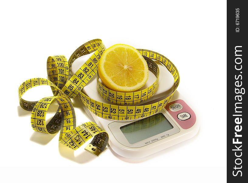 Lemon and tape measure on white