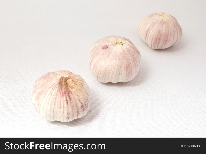 Garlic on white cloth, isolated