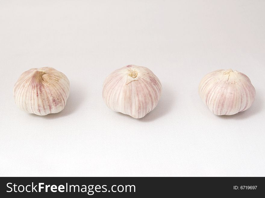 Garlic on white cloth, isolated