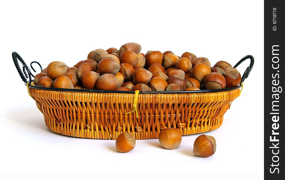 Wood nuts in a basket isolated on a white background. Wood nuts in a basket isolated on a white background