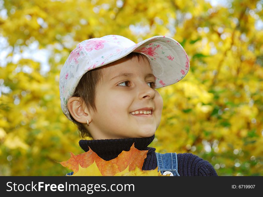 Funny happy child in autumn park