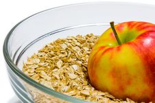 Apple On Oat Flakes Background In A Glass Bowl &x28;front View&x29; Stock Images Apple On Oat Flakes Background In A Glass Bowl &x28;front View&x29; Stock Images