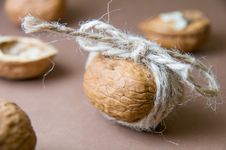 Walnut Tied With Twine On The Blurred Background On A Brown Stock Photo Walnut Tied With Twine On The Blurred Background On A Brown Stock Photo