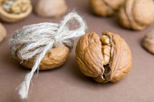 Walnut Tied With Twine And Cracked Walnut On The Background Of O Royalty Free Stock Images Walnut Tied With Twine And Cracked Walnut On The Background Of O Royalty Free Stock Images