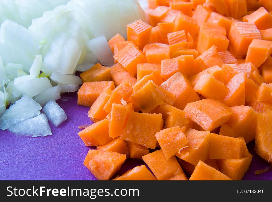 Carrot and onion diced closeup. Orange, White, Purple colors
