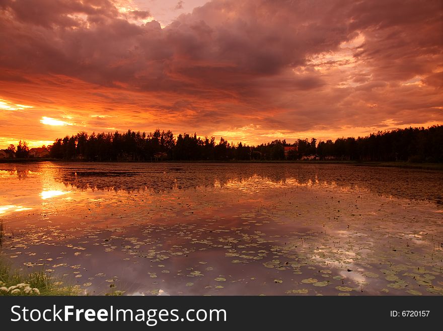 Lake at sunset with reflection in Finland