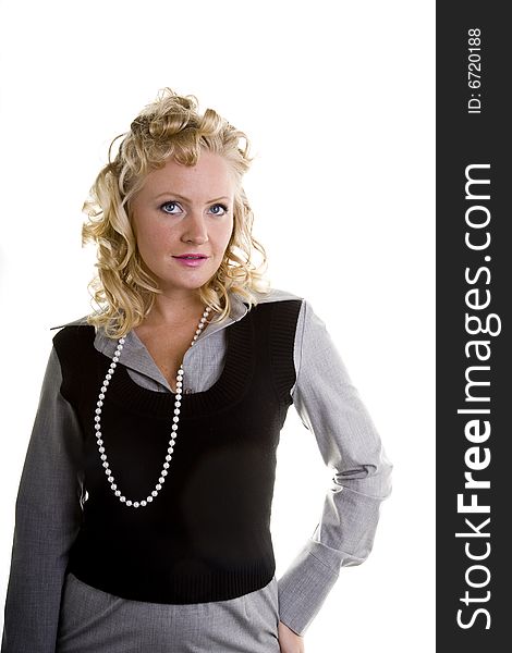 A curly blonde model with pearls and one hand on her hip. A curly blonde model with pearls and one hand on her hip