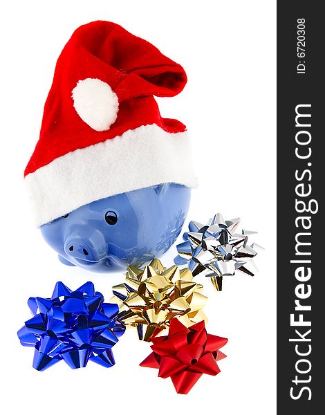 Christmas cap with piggy bank shows symbolically the expenditure at the Christmas purchase
