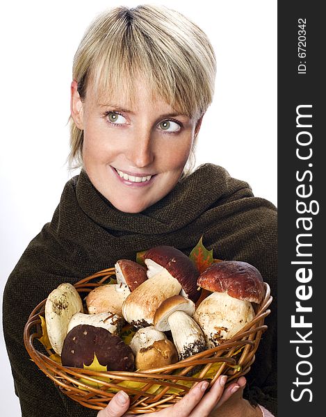 Young blond woman holding mushrooms close up