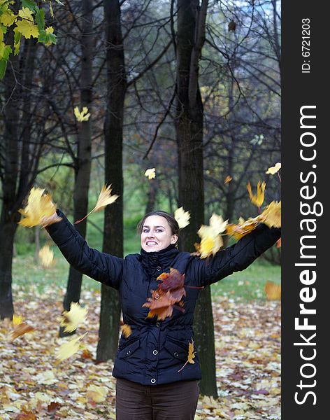 Happy girl throwing leaves in autumn park. Happy girl throwing leaves in autumn park