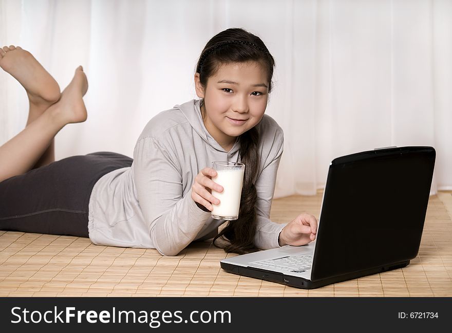 Teenager girl with notebook and glass milk