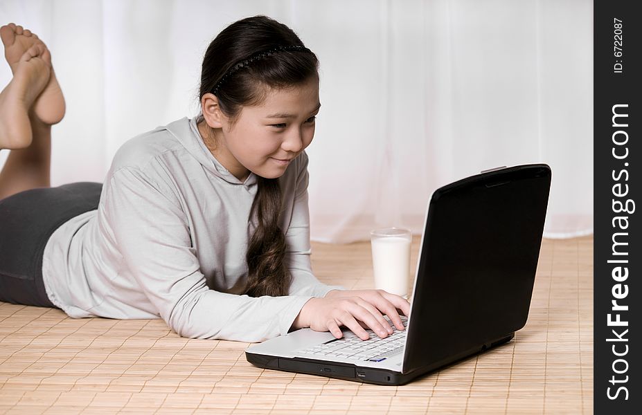 Teenager girl with notebook and glass milk