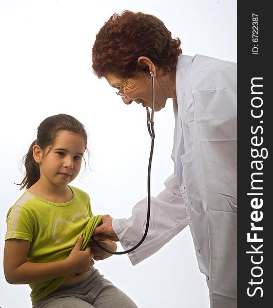 Senior women doctor examining a young girl patient. Senior women doctor examining a young girl patient