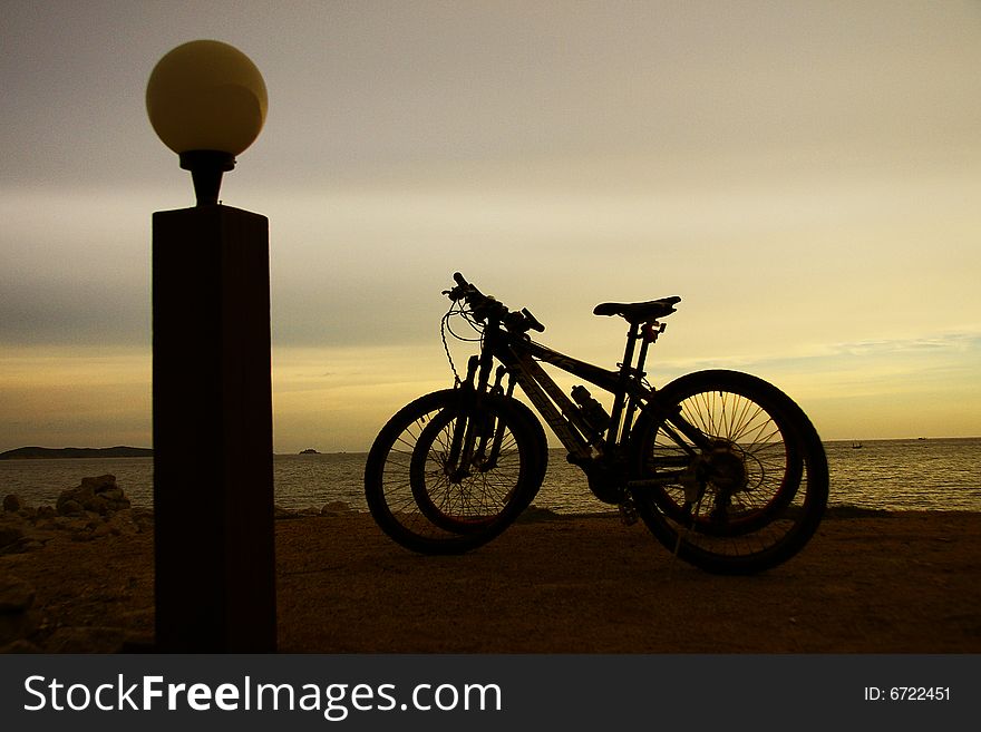 Bicycles on the evening beach and sundown. Bicycles on the evening beach and sundown