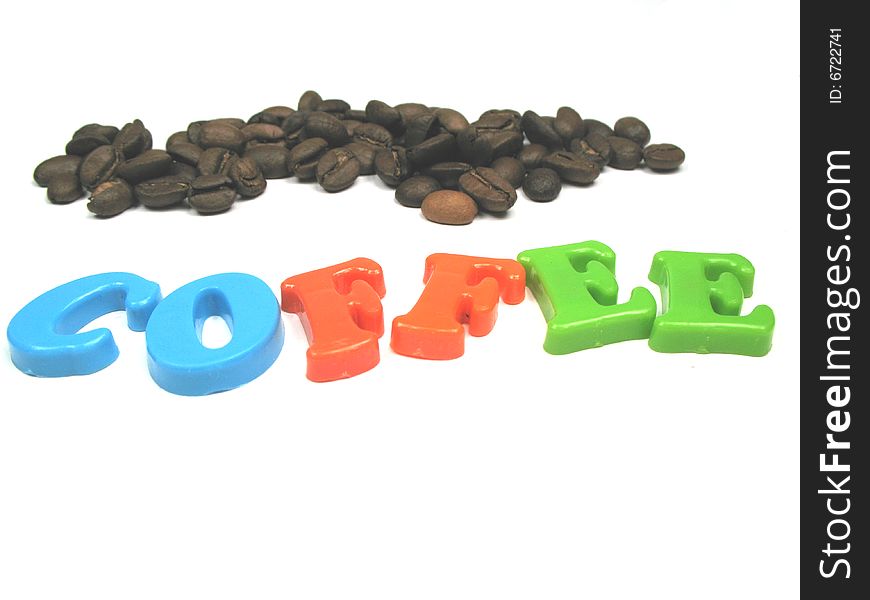 The word coffee in front of some beans