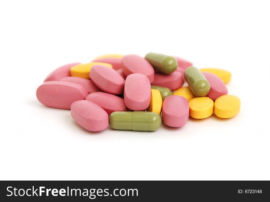 Colourful pills isolated on white backgrounder