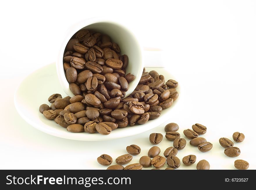White coffee cup and coffee beans on a light background