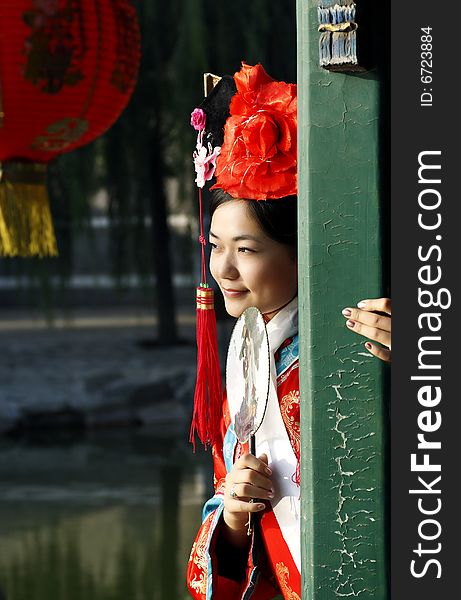 A beautiful girl in Chinese ancient dress is in the royal garden.This is dress of Qing Dynasty of China. It is the princess' dress too. It is a New Year picture of China to draw on the lantern. Chinese on the fan is meant and missed. A beautiful girl in Chinese ancient dress is in the royal garden.This is dress of Qing Dynasty of China. It is the princess' dress too. It is a New Year picture of China to draw on the lantern. Chinese on the fan is meant and missed.