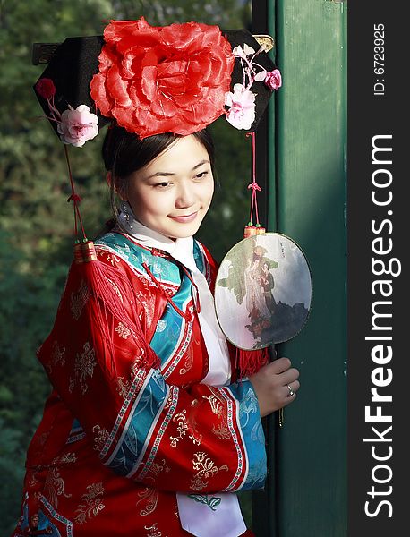 Portrait of a beautiful girl in Chinese ancient dress. 

 This is dress of Qing Dynasty of China. It is the princess' dress too.

Chinese on the fan is meant and missed. Portrait of a beautiful girl in Chinese ancient dress. 

 This is dress of Qing Dynasty of China. It is the princess' dress too.

Chinese on the fan is meant and missed.