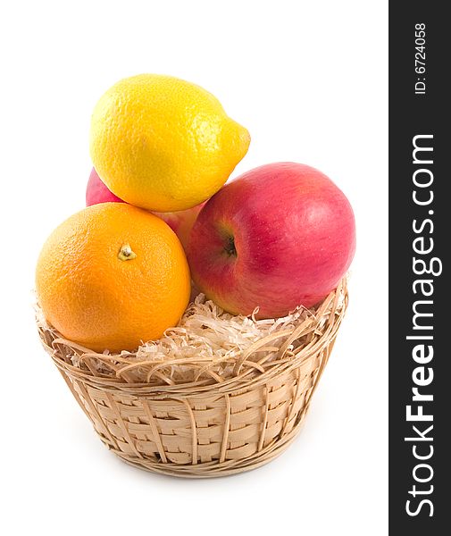 Ripe and beautiful fruit orange apples lemon in yellow basket on white background. Ripe and beautiful fruit orange apples lemon in yellow basket on white background