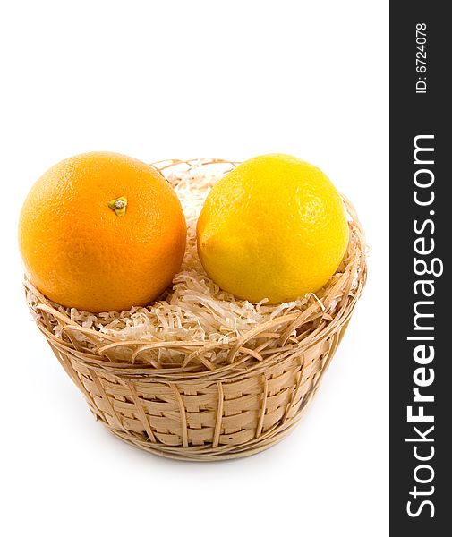 Yellow lemon in basket together with beautiful tasty orange on white background. Yellow lemon in basket together with beautiful tasty orange on white background