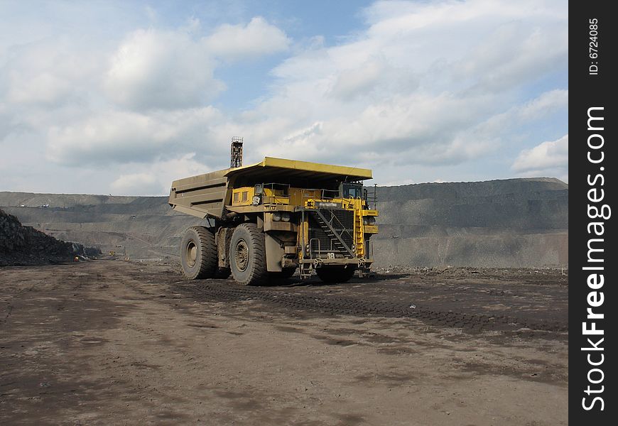 Dump truck carries coal on cut