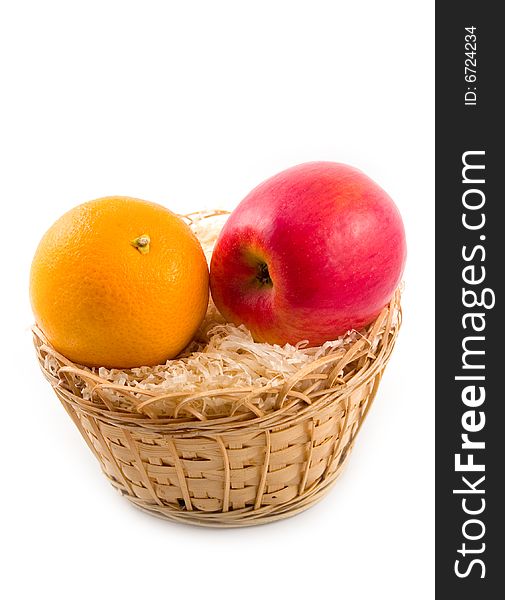 Beautiful orange and tasty red plant apple in yellow basket on white background
