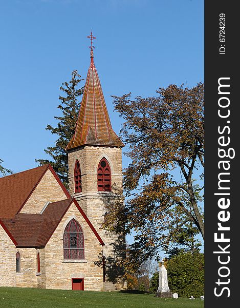 With a cloudless sky as the backdrop, the rising sun illuminates an old church. With a cloudless sky as the backdrop, the rising sun illuminates an old church.