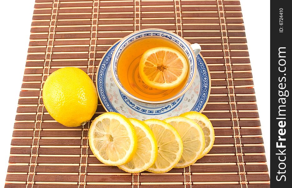 Fragrant tasty useful tea with lemon cup with blue figure on napkin strip. Fragrant tasty useful tea with lemon cup with blue figure on napkin strip