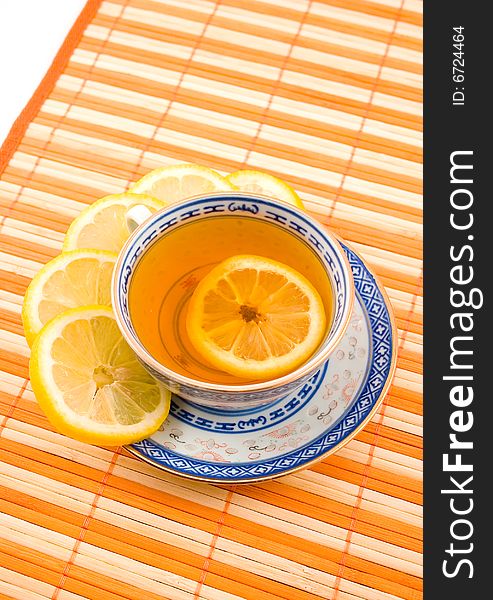 Fragrant tasty useful tea with lemon cup with blue figure on napkin strip