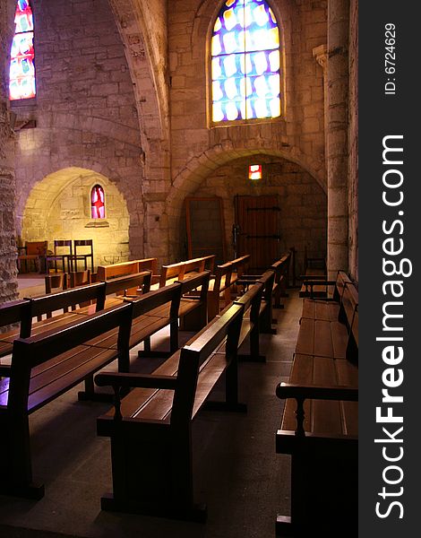 Warm light on the benches in a small church, Aigues Mortes, France. Warm light on the benches in a small church, Aigues Mortes, France.