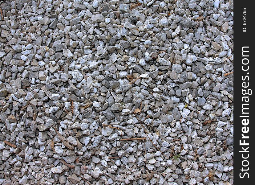 Gravel surface with dry autumn leaves and sticks on. Gravel surface with dry autumn leaves and sticks on.