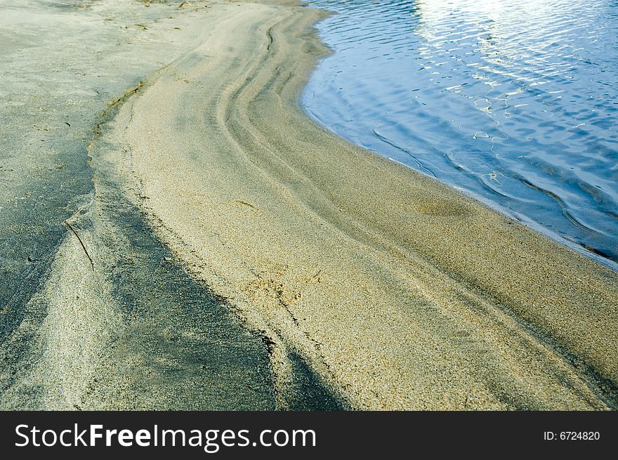 Small sand dunes made by the waves of a lake. Small sand dunes made by the waves of a lake