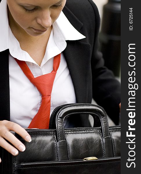 Outdoor portrait of businesswoman with briefcase
