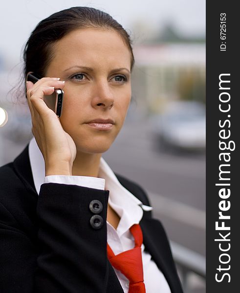 Pretty businesswoman talking by mobile phone