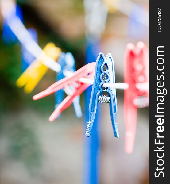 Colorful clothespins hanging on a rope. Colorful clothespins hanging on a rope