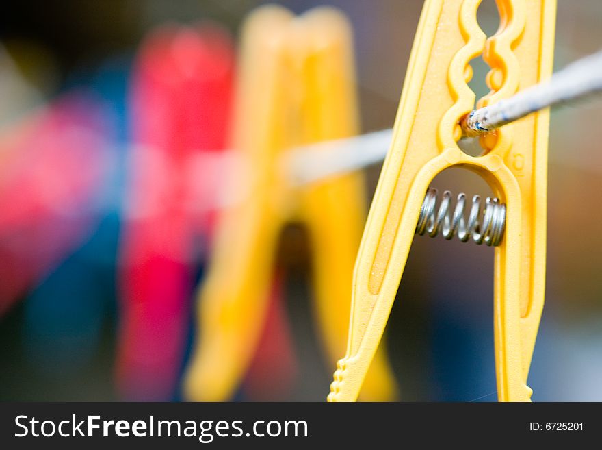 Colorful clothespins hanging on a rope. Colorful clothespins hanging on a rope