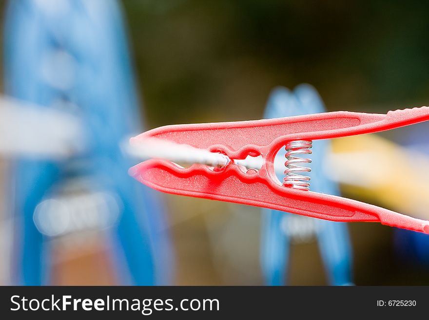 Colorful clothespins hanging on a rope. Colorful clothespins hanging on a rope